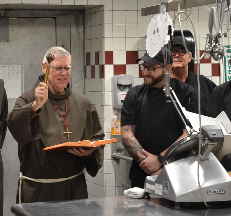Father Dennis blessing the new kitchen